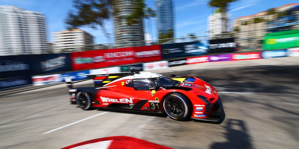 The Red Cadillac V-Series.R Race Car Speeding Around the Curve of the Race Track
