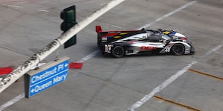 The Red V-Series.R Racecar Being Worked on at the Track's Pit Stop