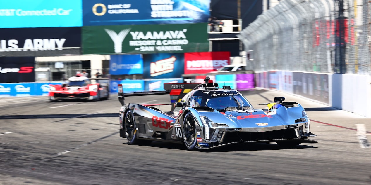 The Silver Cadillac V-Series.R Race Car Ahead of Other Vehicles on the Track