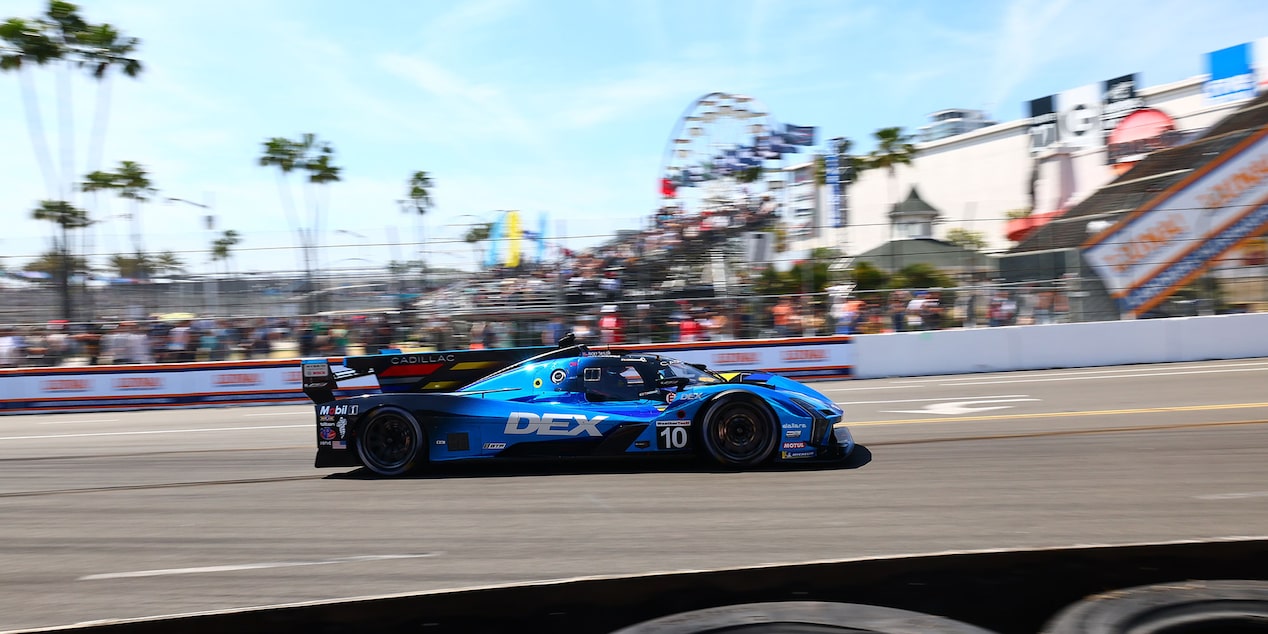 Side View of the Blue Cadillac V-Series.R Race Car Driving on the Track