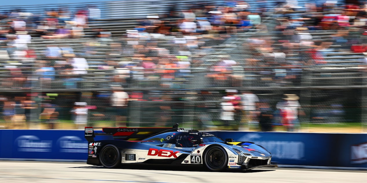 Side View of the Silver Cadillac V-Series.R Race Car Speeding on the Race Track