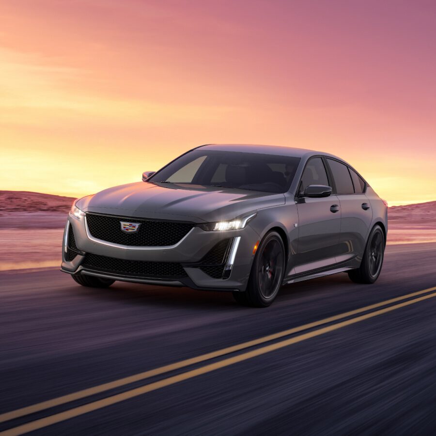 2024 Cadillac CT5 Speeding on a Road During Sunset With Mountains in The Background