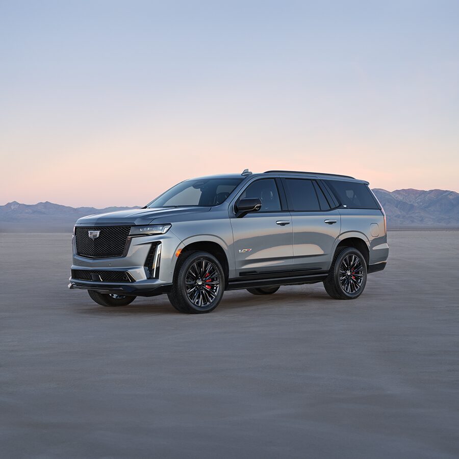 2023 Cadillac Escalade V Parked on Sand With Mountains Protruding in The Background