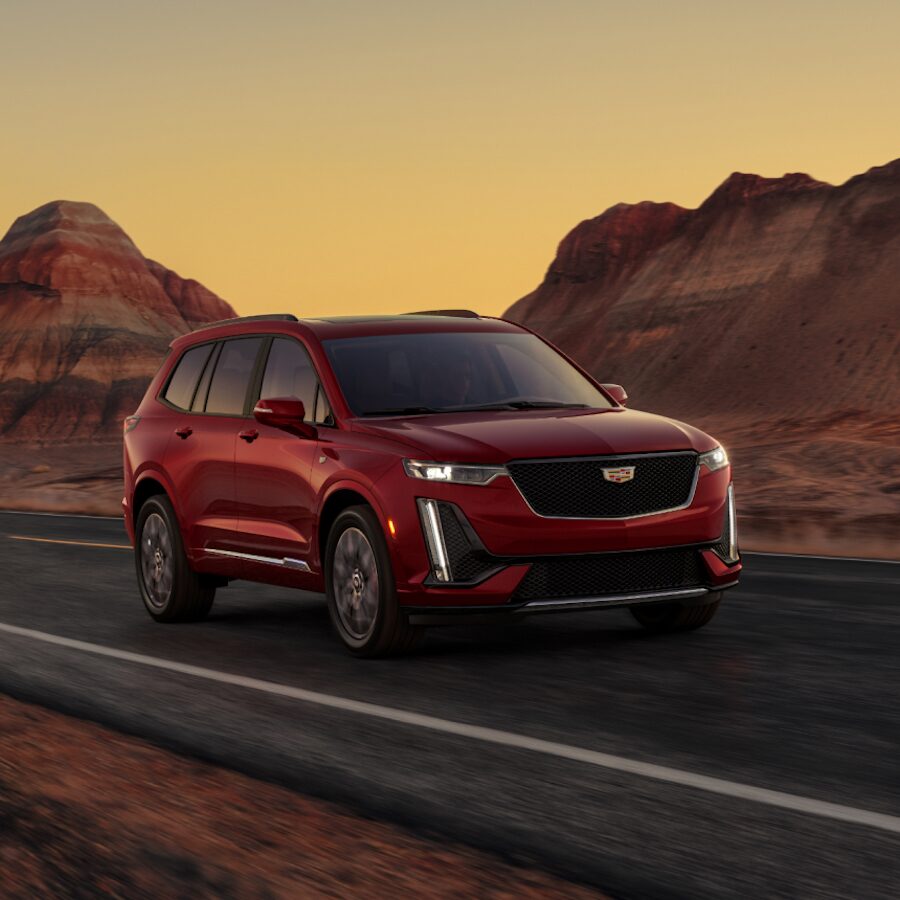 2024 Cadillac XT6 Driving on a Scenic Road With Red Rocks Along the Side