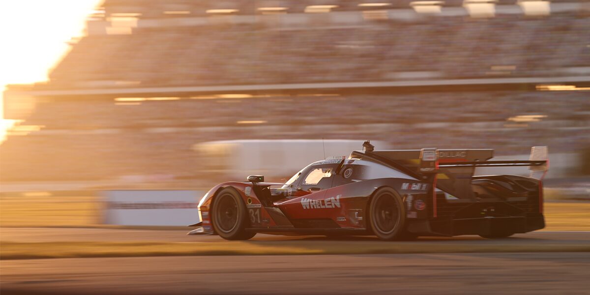 Front View of the Red V-Series.R Racecar Speeding Down on a Track