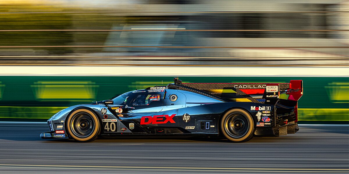 A Blurry Side View of the Yellow V-Series.R Racecar Speeding Down a Track