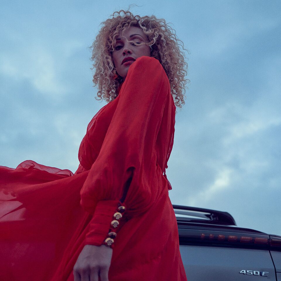 Woman Stands Near Cadillac LYRIQ