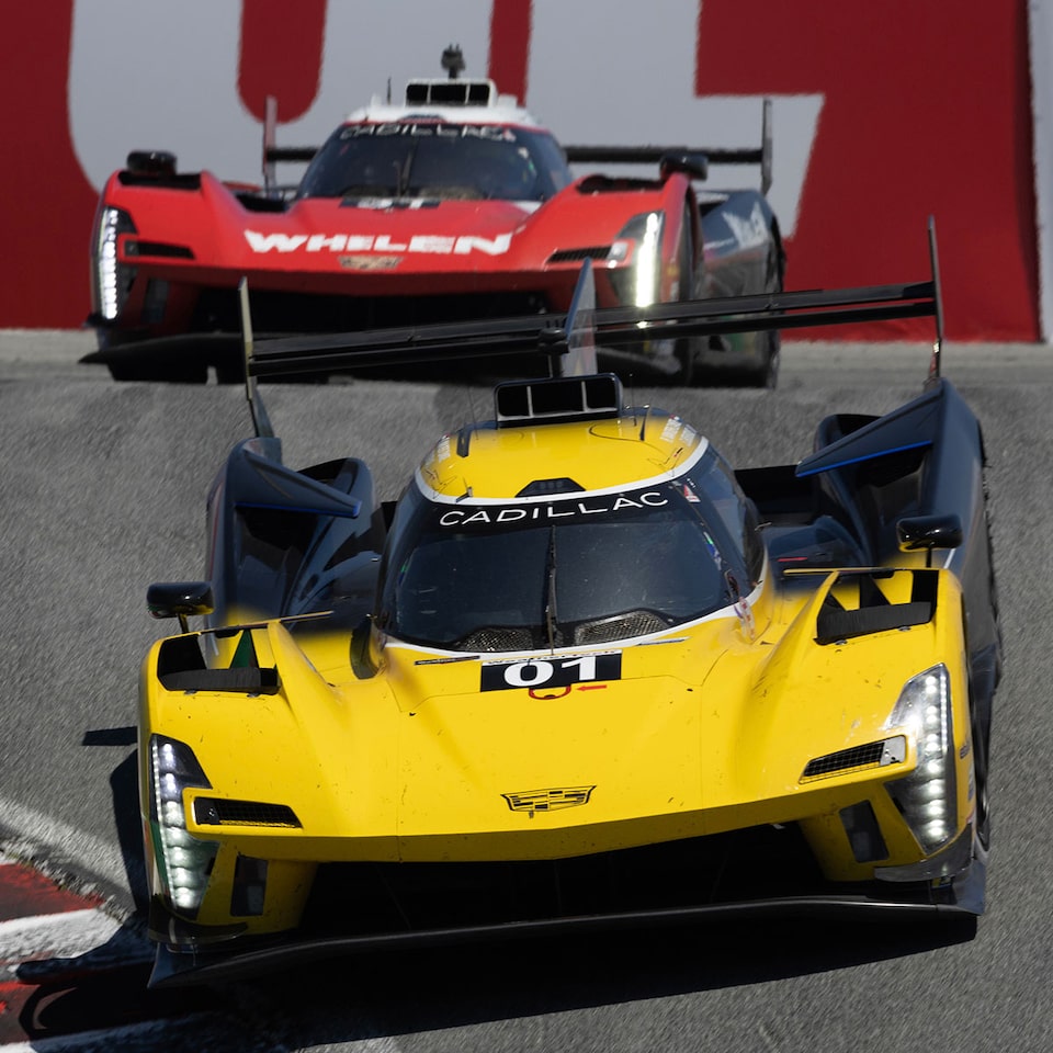 Cadillac LMDh Race Cars Racing in Line on Track