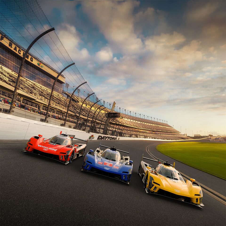 Cadillac LMDh Race Cars Racing in Line on Track