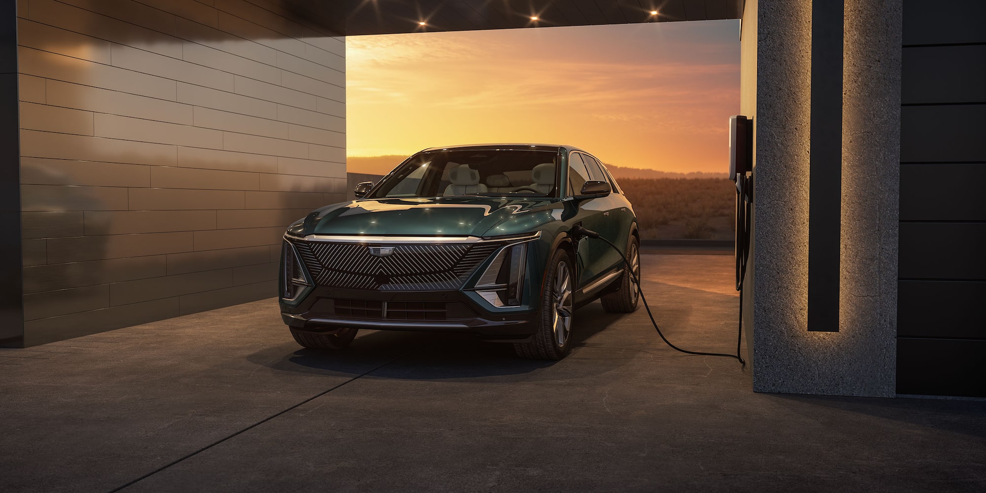 2024 Cadillac LYRIQ in Emerald Green Metallic parked at charging station in the desert. 