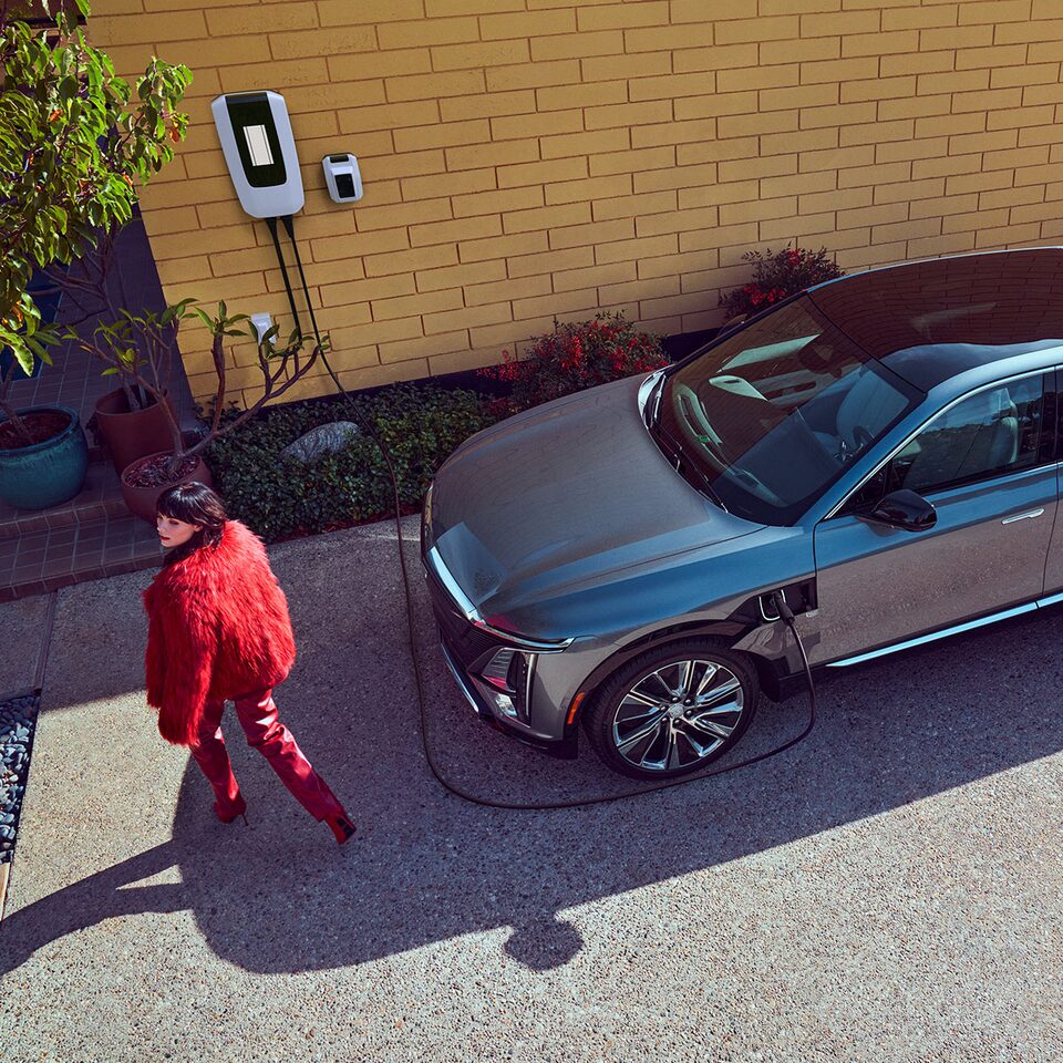An Aerial Shot of A Woman Leaving Her LYRIQ to Charge